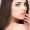 Closeup of sensuous woman with long and brown hair in studio